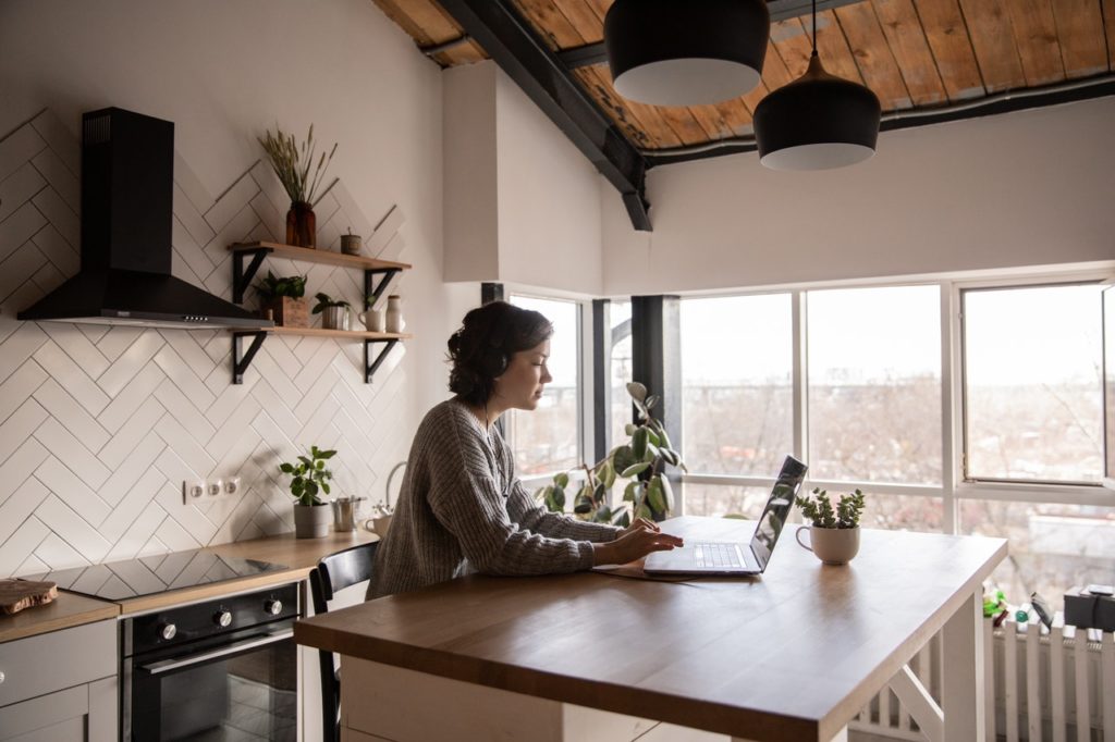 A woman researches building equity on her laptop.